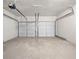 Spacious two-car garage featuring smooth concrete floors and two white panel garage doors at 826 Shore Dr, Lithonia, GA 30058