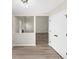 Hallway showing modern lighting, wood floors and a view into the living room with a white fireplace at 826 Shore Dr, Lithonia, GA 30058