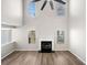 Bright living room with a soaring ceiling, modern ceiling fan, fireplace, and beautiful flooring at 826 Shore Dr, Lithonia, GA 30058