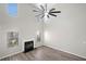 Bright living room with a soaring ceiling, modern ceiling fan, fireplace, and beautiful flooring at 826 Shore Dr, Lithonia, GA 30058