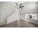 Bright living room featuring new laminate floors, high ceilings and a view into the kitchen with white cabinets at 826 Shore Dr, Lithonia, GA 30058