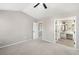 Main bedroom with neutral carpet, ceiling fan and an ensuite bathroom with a vanity at 826 Shore Dr, Lithonia, GA 30058