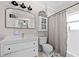 Bright bathroom featuring a modern vanity with a vessel sink and an arched mirror with black trim at 1015 Michigan Nw Ave, Atlanta, GA 30314