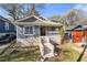 Charming renovated craftsman with inviting front porch, blue siding, and concrete stairs at 1015 Michigan Nw Ave, Atlanta, GA 30314