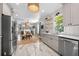 Bright kitchen featuring tile floors, stainless steel appliances, custom cabinets, and open shelving at 1015 Michigan Nw Ave, Atlanta, GA 30314