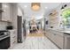 Beautiful open-concept kitchen with modern appliances, tile flooring, and access to the living and dining areas at 1015 Michigan Nw Ave, Atlanta, GA 30314