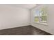 Charming bedroom with dark hardwood floors and a bright window overlooking the neighborhood at 1079 Blue Juniper Cir, Loganville, GA 30052