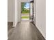 Welcoming entryway with wood-look floors leading to an open view of the outside and the home's exterior at 1079 Blue Juniper Cir, Loganville, GA 30052