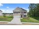 Charming two-story home with a two-car garage, manicured lawn, and beautiful landscaping at 1079 Blue Juniper Cir, Loganville, GA 30052