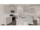 Stylish kitchen showcasing gray cabinetry, stainless appliances, and a kitchen island with white countertops at 1079 Blue Juniper Cir, Loganville, GA 30052