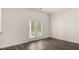 Bright room with dark wood flooring and french doors leading to the outdoors at 1079 Blue Juniper Cir, Loganville, GA 30052