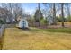 Expansive grassy backyard with shed and mature trees, enclosed by a chain-link fence at 1107 Sanfords Walk, Tucker, GA 30084