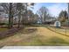 Backyard featuring a shed, chain link fence, and trees in the distance at 1107 Sanfords Walk, Tucker, GA 30084