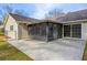 Back patio with enclosed porch addition, concrete patio area and large yard at 1107 Sanfords Walk, Tucker, GA 30084