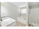 Bathroom featuring granite countertops, soaking tub, and a separate shower stall at 1107 Sanfords Walk, Tucker, GA 30084