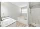 Bathroom featuring a granite countertop vanity, a soaking tub, and a separate shower at 1107 Sanfords Walk, Tucker, GA 30084