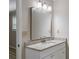 Updated bathroom vanity with white cabinets, granite countertop, and modern mirror and lighting at 1107 Sanfords Walk, Tucker, GA 30084