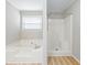 Bright bathroom with a soaking tub and a separate shower, perfect for relaxation at 1107 Sanfords Walk, Tucker, GA 30084