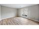 Bedroom with light gray walls, wood floors, and a large window at 1107 Sanfords Walk, Tucker, GA 30084