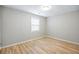 Bright bedroom featuring wood-look flooring and a large window for natural light at 1107 Sanfords Walk, Tucker, GA 30084