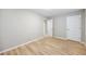 Cozy bedroom featuring wood-look flooring and a classic white door for closet access at 1107 Sanfords Walk, Tucker, GA 30084