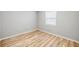 Bright bedroom featuring wood-look flooring and a window providing natural light at 1107 Sanfords Walk, Tucker, GA 30084