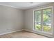 Bright bedroom features hardwood flooring, neutral walls and a large window for natural light at 1107 Sanfords Walk, Tucker, GA 30084