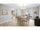 Bright dining room with wood floors, large windows, and elegant chandelier at 1107 Sanfords Walk, Tucker, GA 30084