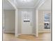 Entryway with white front door and wood floors at 1107 Sanfords Walk, Tucker, GA 30084