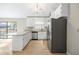 Well-lit kitchen featuring white cabinets, modern appliances, and a sliding glass door at 1107 Sanfords Walk, Tucker, GA 30084