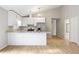 Spacious kitchen with white cabinetry, stainless steel refrigerator, and views to hallway at 1107 Sanfords Walk, Tucker, GA 30084