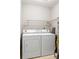 Laundry room features a white washer and dryer and a metal shelf at 1107 Sanfords Walk, Tucker, GA 30084