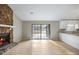 Living room features stone fireplace, neutral paint, wood-look flooring, and access to the kitchen and backyard at 1107 Sanfords Walk, Tucker, GA 30084