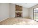 Living room featuring a stone fireplace and natural light from the sliding glass door at 1107 Sanfords Walk, Tucker, GA 30084