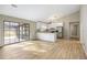 Open-concept living room and kitchen area with access to the backyard through a sliding glass door at 1107 Sanfords Walk, Tucker, GA 30084
