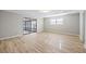 Cozy living room showcasing light wood flooring and access to the screened porch through sliding glass doors at 1107 Sanfords Walk, Tucker, GA 30084