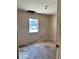 Bedroom showcasing a window, damaged walls, and unfinished floors with visible wiring at 13101 Waldrop Cv, Decatur, GA 30034