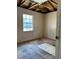 Bedroom featuring damaged walls, unfinished floors, and a window letting in natural light at 13101 Waldrop Cv, Decatur, GA 30034