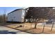 Exterior of a multi-story building showcasing simple architecture and an adjacent parking area at 13101 Waldrop Cv, Decatur, GA 30034