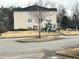 Exterior view of a three-story building with a playground in the front yard at 13101 Waldrop Cv, Decatur, GA 30034