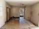 Unfinished living room with wall damage and unfinished floors with a view into another room at 13101 Waldrop Cv, Decatur, GA 30034