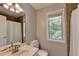 Functional bathroom featuring a single sink vanity, toilet, and a shower/tub combo at 5080 Firelight Ln, Alpharetta, GA 30022