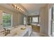 Bright bathroom with a double vanity and garden tub with a large window with a view to the outside at 5080 Firelight Ln, Alpharetta, GA 30022