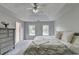 Bright bedroom featuring a large bed, neutral walls, and two large windows for natural light at 5080 Firelight Ln, Alpharetta, GA 30022