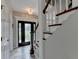 Bright foyer with decorative front door and staircase with white risers and stained wood trim at 5080 Firelight Ln, Alpharetta, GA 30022