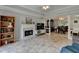 Bright and airy living room with fireplace, modern flooring, and seamless flow to the dining area at 5080 Firelight Ln, Alpharetta, GA 30022