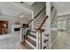 Open stairway connecting to living areas featuring wood stairs and white railings, creating a seamless flow at 5080 Firelight Ln, Alpharetta, GA 30022