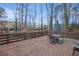 Spacious back deck ideal for outdoor entertaining, with views of a wooded area at 5664 Colton Dr, Atlanta, GA 30342