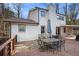 Backyard with a deck and patio set overlooking the wooded backyard at 5664 Colton Dr, Atlanta, GA 30342