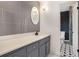 Stylish bathroom featuring modern fixtures, a gray tile accent wall and a decorative floor at 5664 Colton Dr, Atlanta, GA 30342